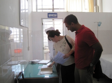 a man in a building looking at something on a table