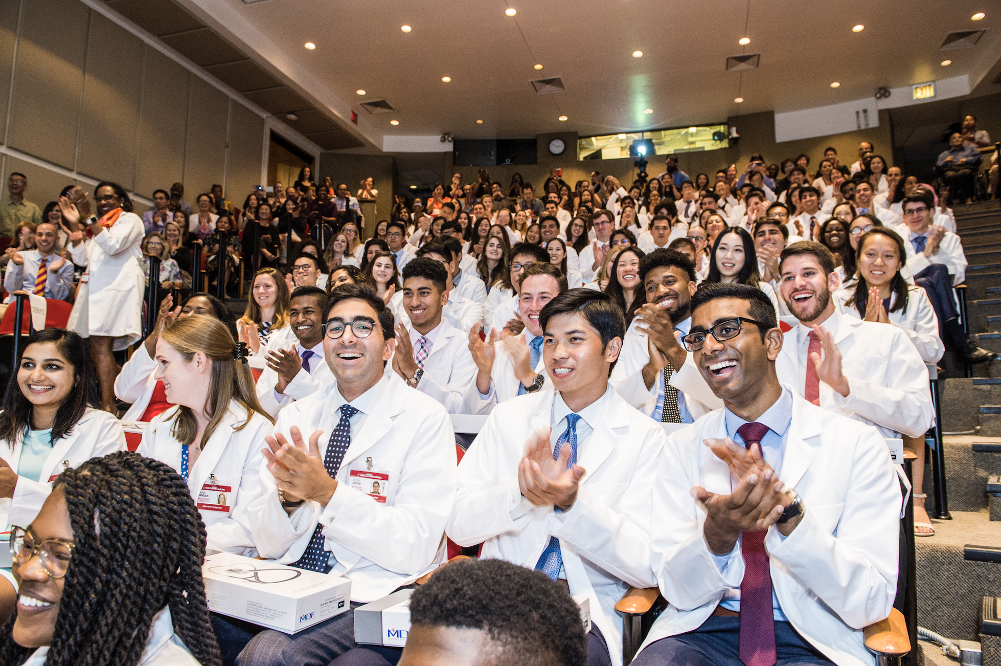 Students from the class of 2023 celebrate in Uris at the end of the White Coat ceremony.