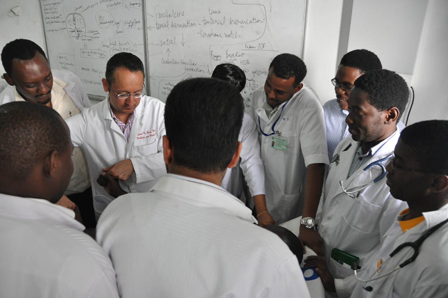 Dr. Hal Mangat conducts rounds with residents at Bugando Medical Centre during a visit in 2012 Photos provided