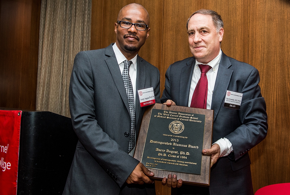 Dr. Avery August accepts the Weill Cornell Graduate School of Medical Sciences Distinguished Alumnus Award from Dr. Gary Koretzky at an awards dinner on May 27. Photo Credit: Studio Brooke