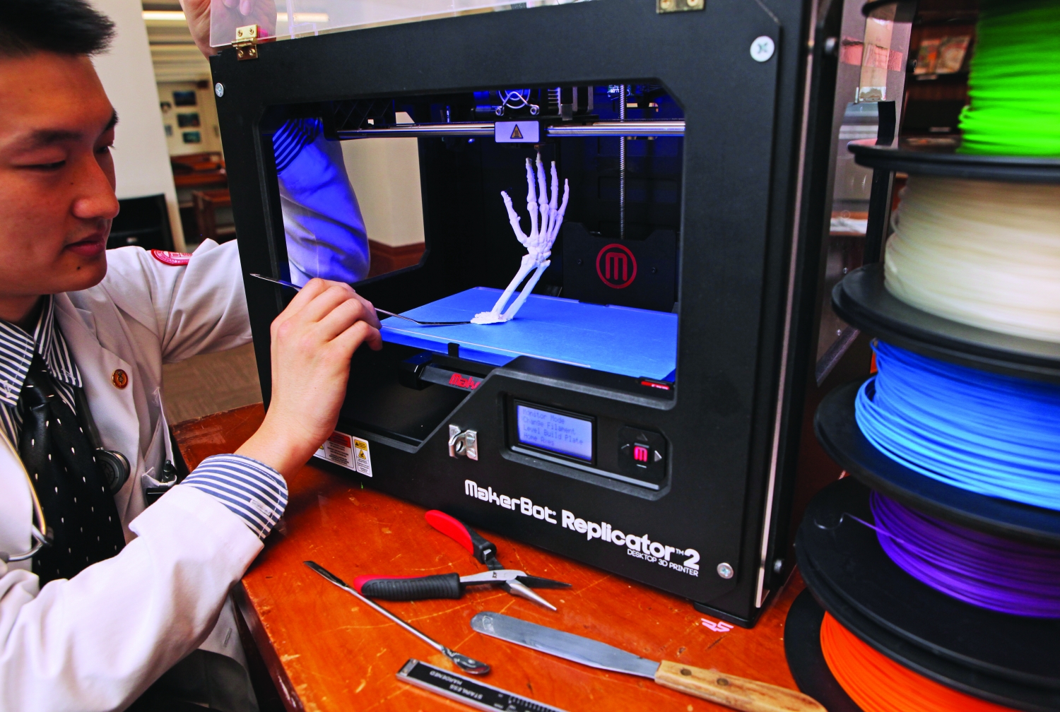 Total fabrication: M.D.-Ph.D. student Du Cheng with the 3D printer. Photo credit: John Abbott