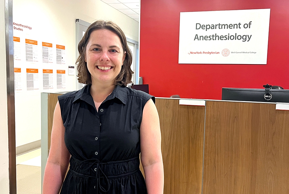 Dr. Dierdre Kelleher in front of a sign for the Dept. of Anesthesiology