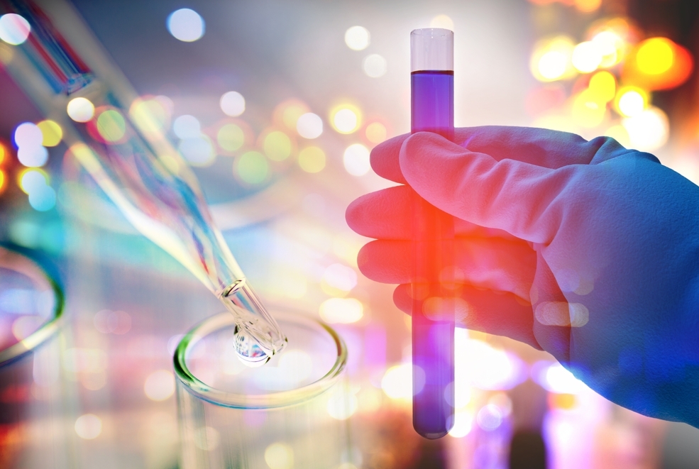 Double exposure of scientist hand holding laboratory test tube. Photo credit: Shutterstock