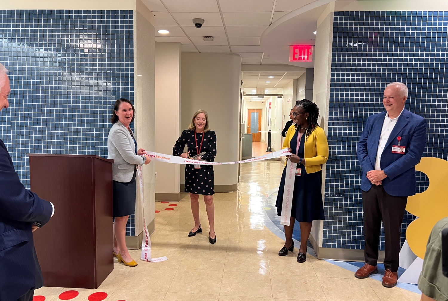 people standing in a new pediatric sub-specialty unit during a ribbon-cutting ceremony