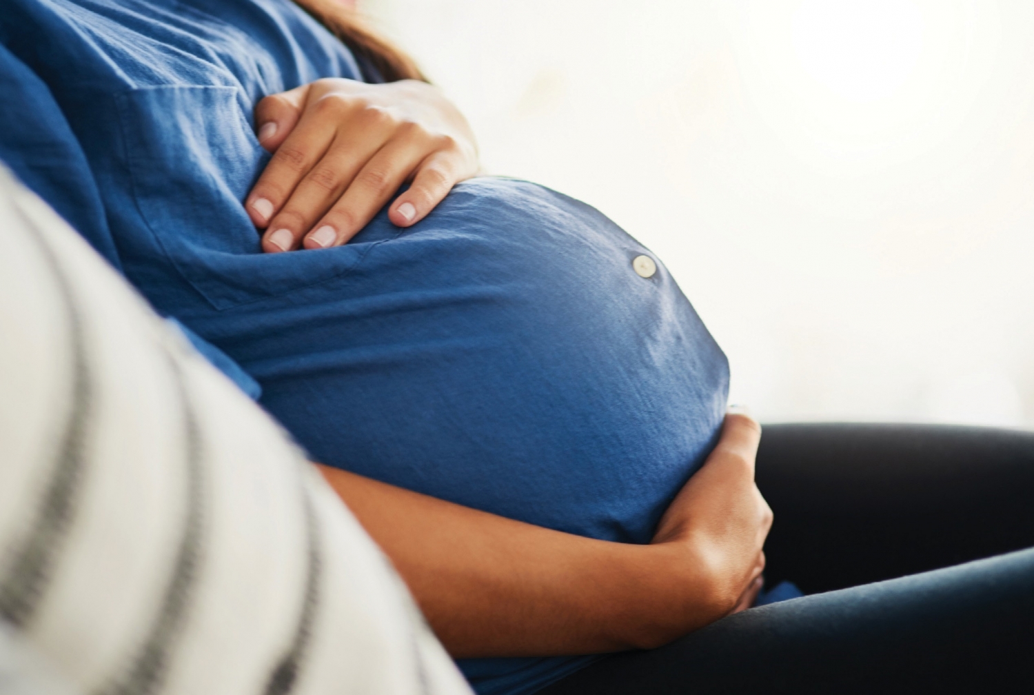 pregnant woman holding her stomach