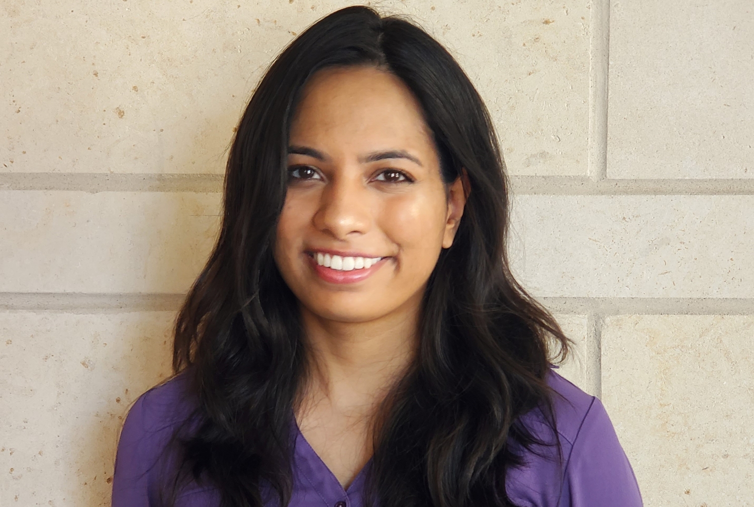 Headshot of a medical student wearing a purple shirt