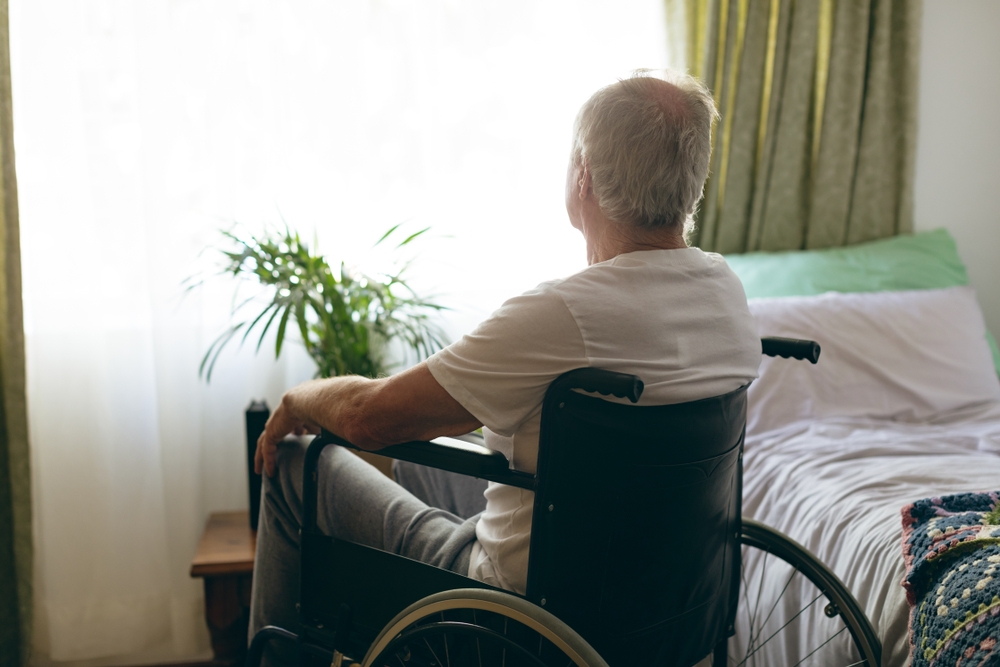 Elderly man sitting in nursing home during quarantine