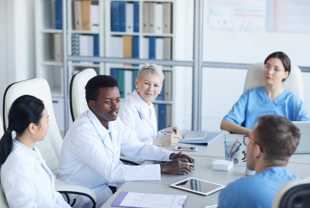 group of doctors sitting around a table