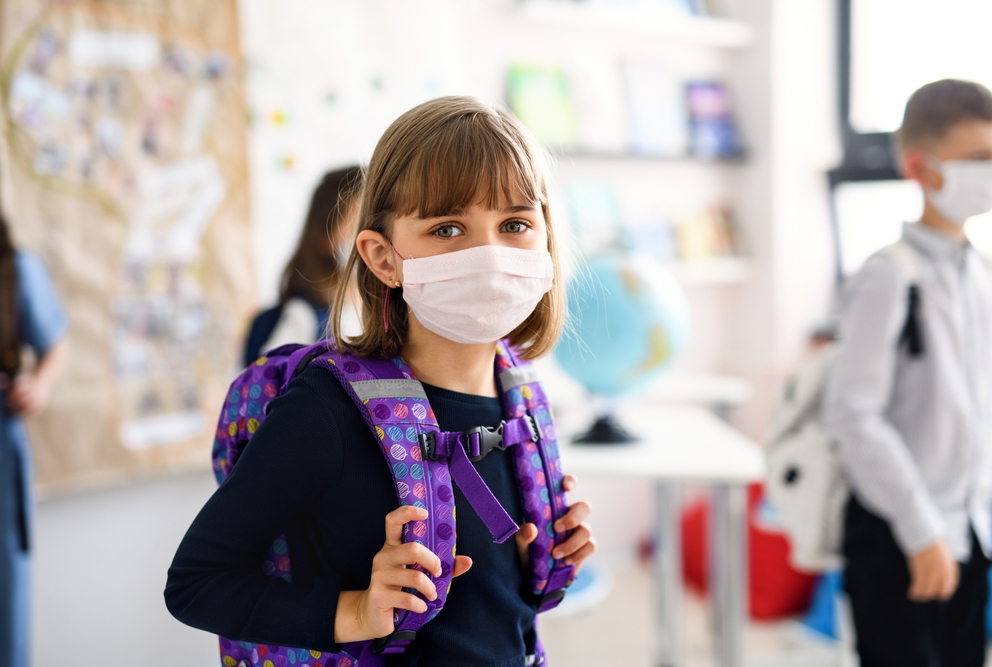 Child with face mask going back to school after covid-19 quarantine and lockdown.