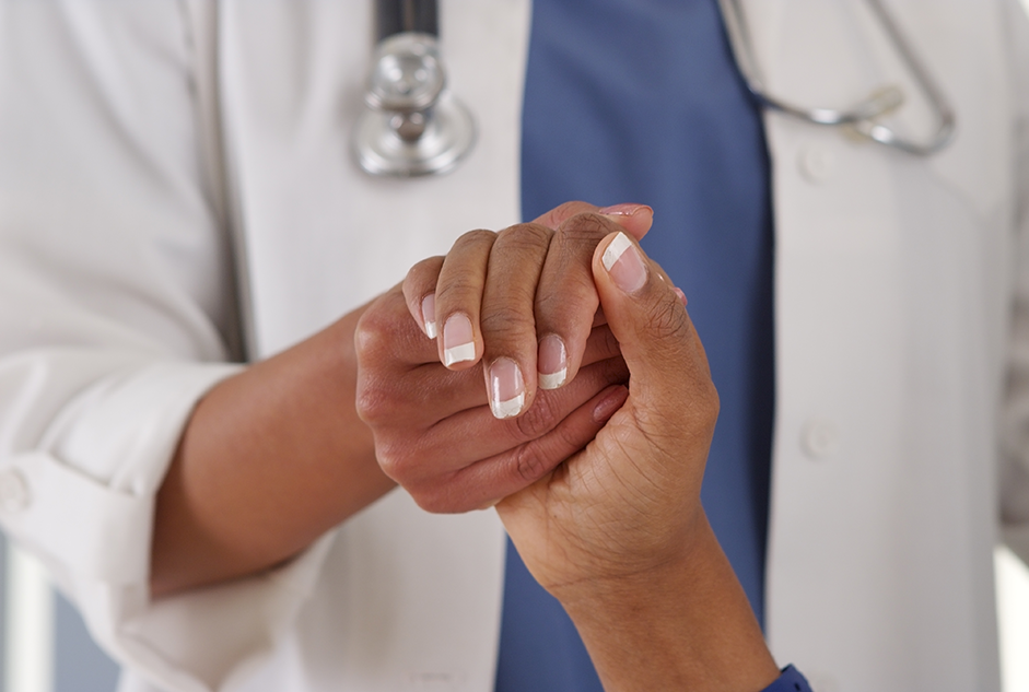 doctor holding patients hand