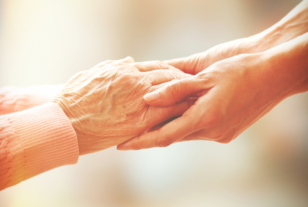 a doctor holding an elders hand