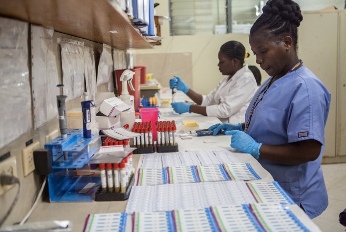 laboratory workers at a bench in Haiti