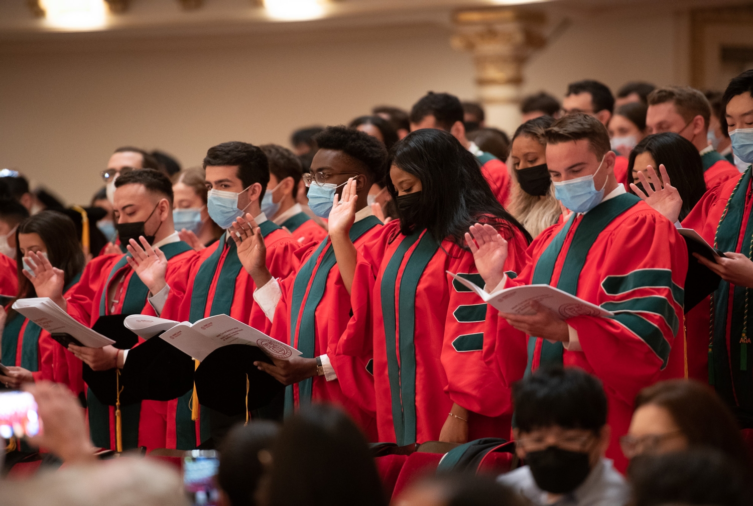 students at graduation reciting the Hippocratic oath.