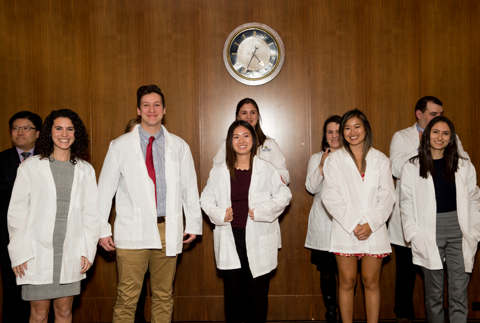 Students wearing white coats