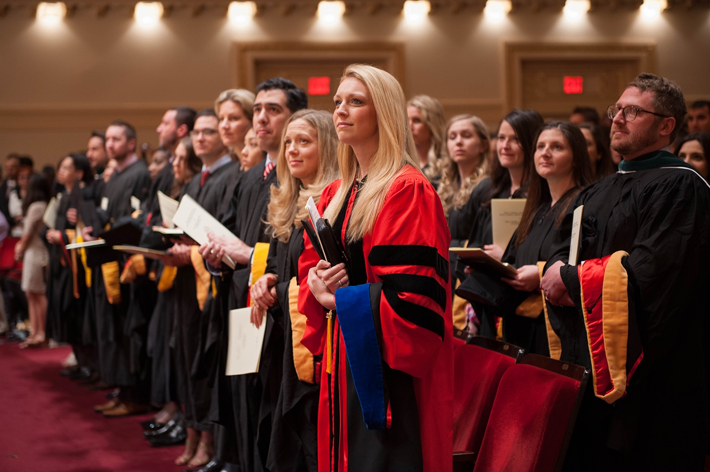 Graduate school commencement speaker Dr. Victoria Schulman stands with her classmates as they are honored during the ceremony