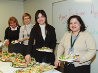 Vera Simonovichene, Galina Kamenetsky, Kin-Ling Cheng, and Mariana Vaismanov, staff of the Physician Organization, line up for food and drink