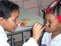Melissa Coleman, '07, shows off her face-painting skills while working in the "Kids Korner."
