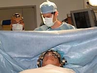 Dr. Yu-Hung Kuo watches as Dr. Michael Kaplitt prepares for the infusion process.