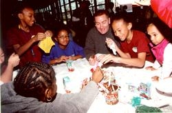 Camp Phoenix kids and NYFD firefighter Michael Lundy express their artistic talents as cake decorators.