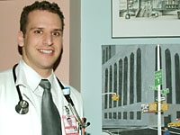 Douglas Weine, Weill Cornell medical student, poses with his award-winning "70th and York" oil painting.