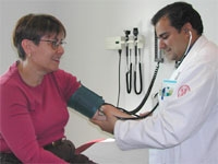 student Michael Nolan performs a blood pressure screening on a NewYork-Presbyterian employee.