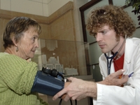 Matthew Horning reads the blood pressure result from Catherine McConnell at Women's Health and Fitness Day.