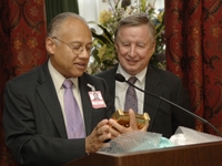 Dean Antonio Gotto gives Dr. Ballard a Tiffany clock engraved with his name and titles.
