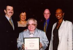 Norma Resignato, holding the Certificate of Appreciation she received at her retirement party