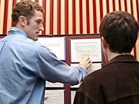Donald Cannon describes his research on plasmas to classmate Milan Lombardi, '08.