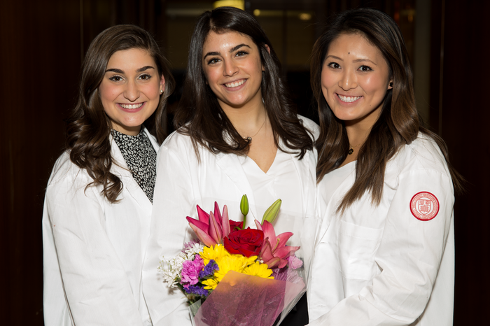 Nicole Simon, Mia Ruggiero and Michelle Chen pose together after receiving their white coats.