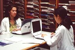 Third-year medical students Natasha Herron and Quanjing Liu use the Library's new Macintosh iBooks to work on a project.
