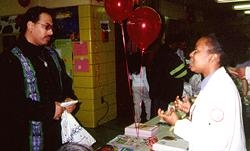 Second-year medical student Simone Porter talks to fairgoers about hypertension.