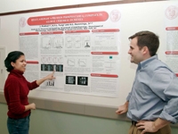Jimcy Platholi reviews her research on cerebral ischemia with Andy Bullock