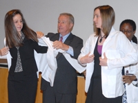 Dean Gotto and Dr. Boutin-Foster assisted the Class of 2012 into their white coats.