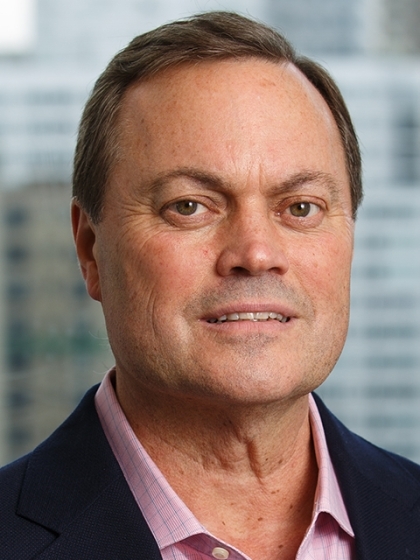 a man in a suit posing for a picture