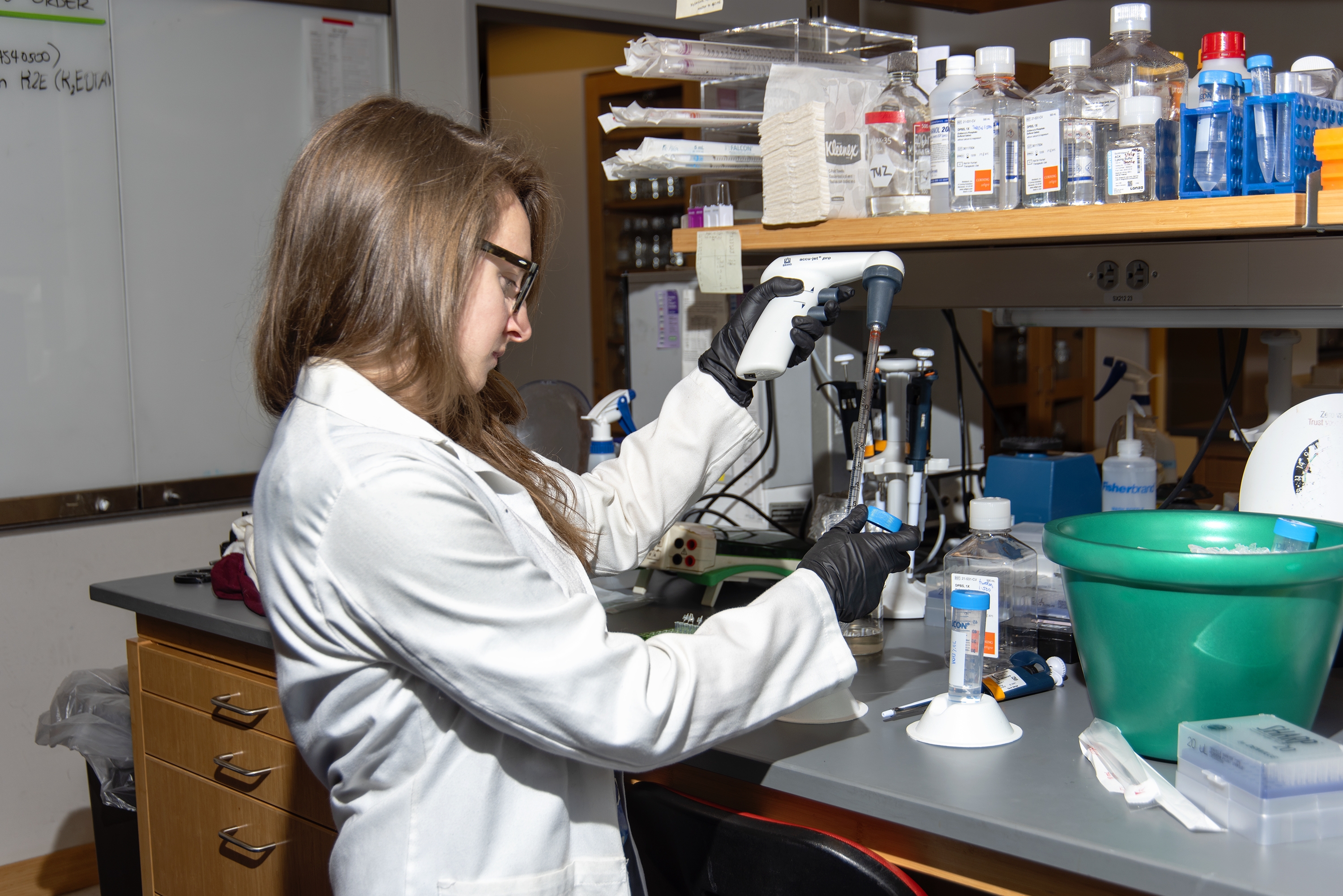 A female M.D.-Ph.D. student working in a lab.