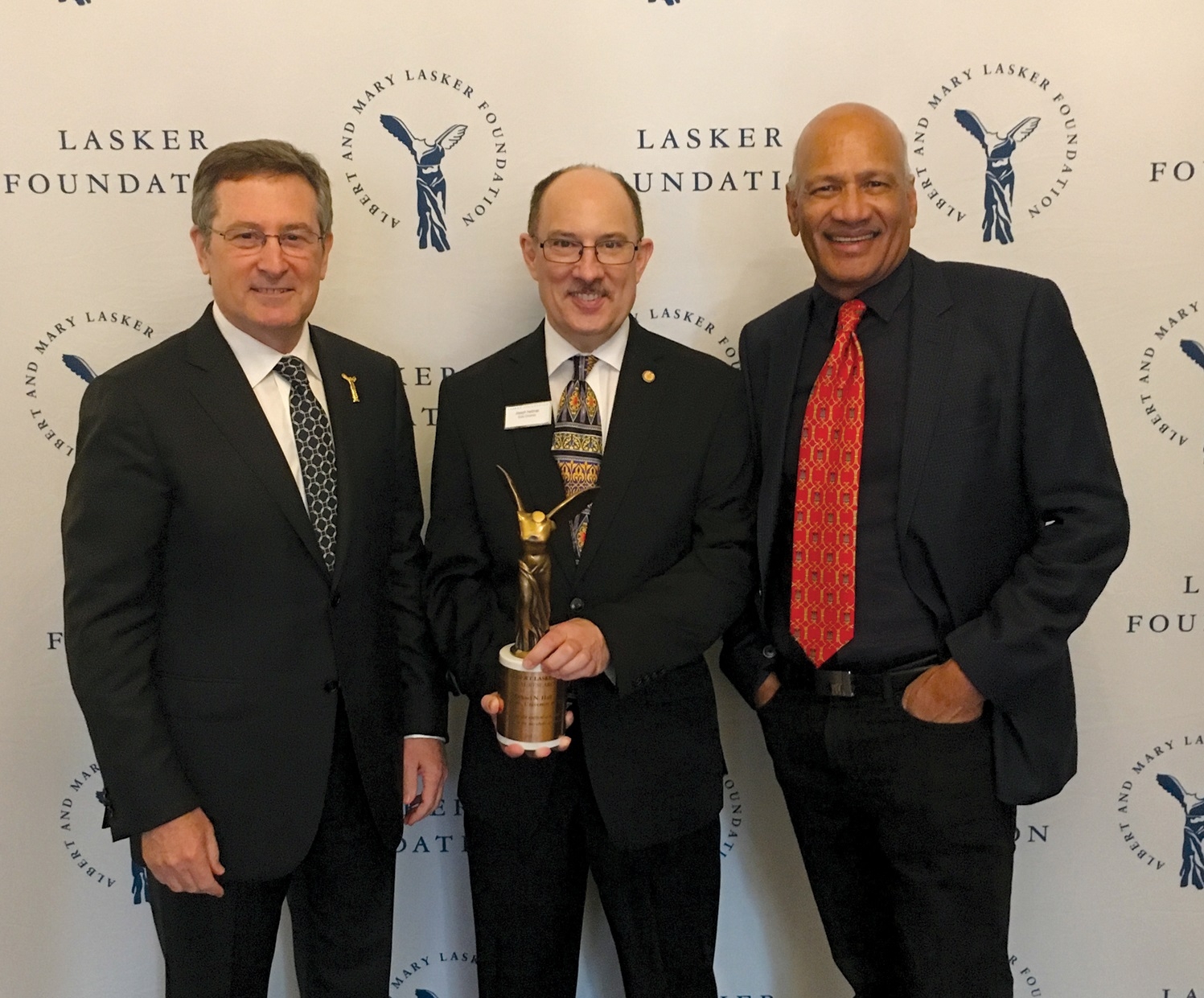 Heitman (above center) at the Lasker Awards ceremony with former research collaborators Hall (left) and Movva. Right: In the lab in Basel in 1990. Opposite page: In his Duke lab today.