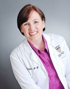 a woman posing for a headshot