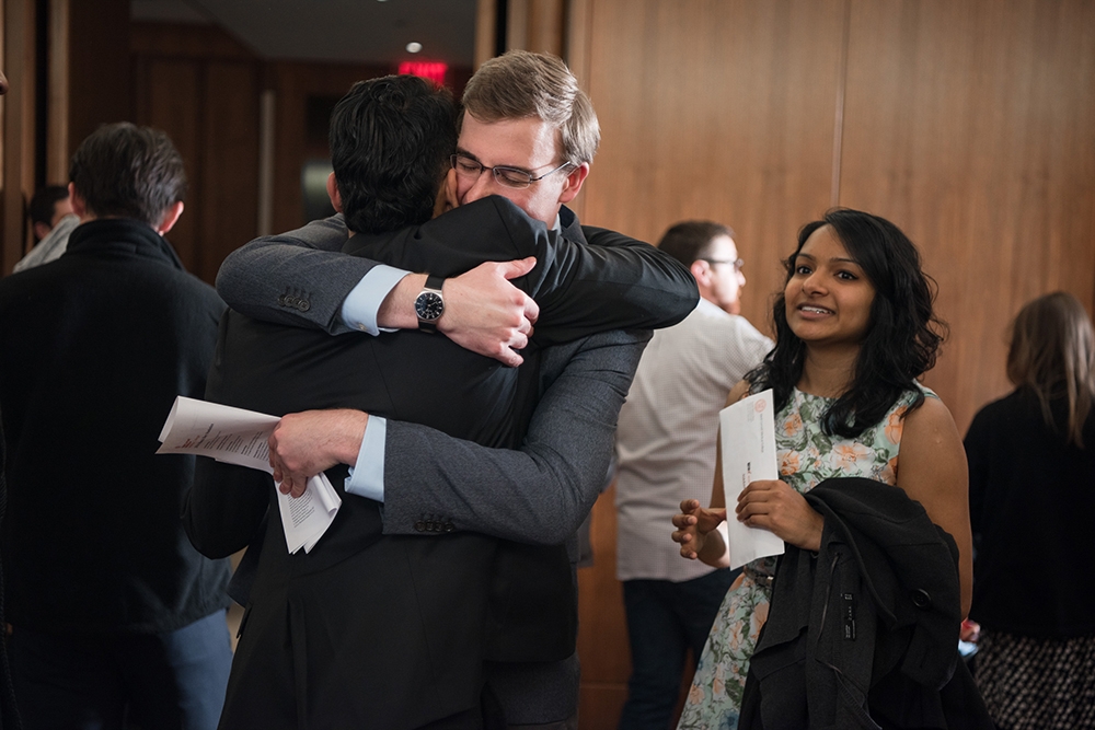 Nick Maston (background) hugs Kartik Viswanathan, while Maston's girlfriend Nikkan Das looks on. Nick Maston, Kartik Viswanathan and Nikkan Das