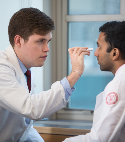 Anthony Palillo ’22 (left) practices performing a neurological exam on classmate Ananth Punyala ’22 during their Brain and Behavior module.