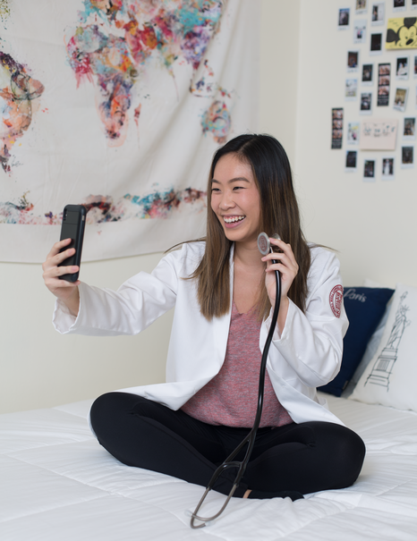 Staying in Touch: Natalie Nguyen ’23 shows off her stethoscope while video chatting with her boyfriend from her dorm room.