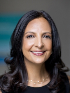 a brown skinned woman posing for a headshot.