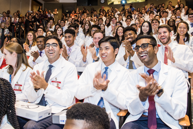 Students from the class of 2023 celebrate in Uris at the end of the White Coat ceremony.